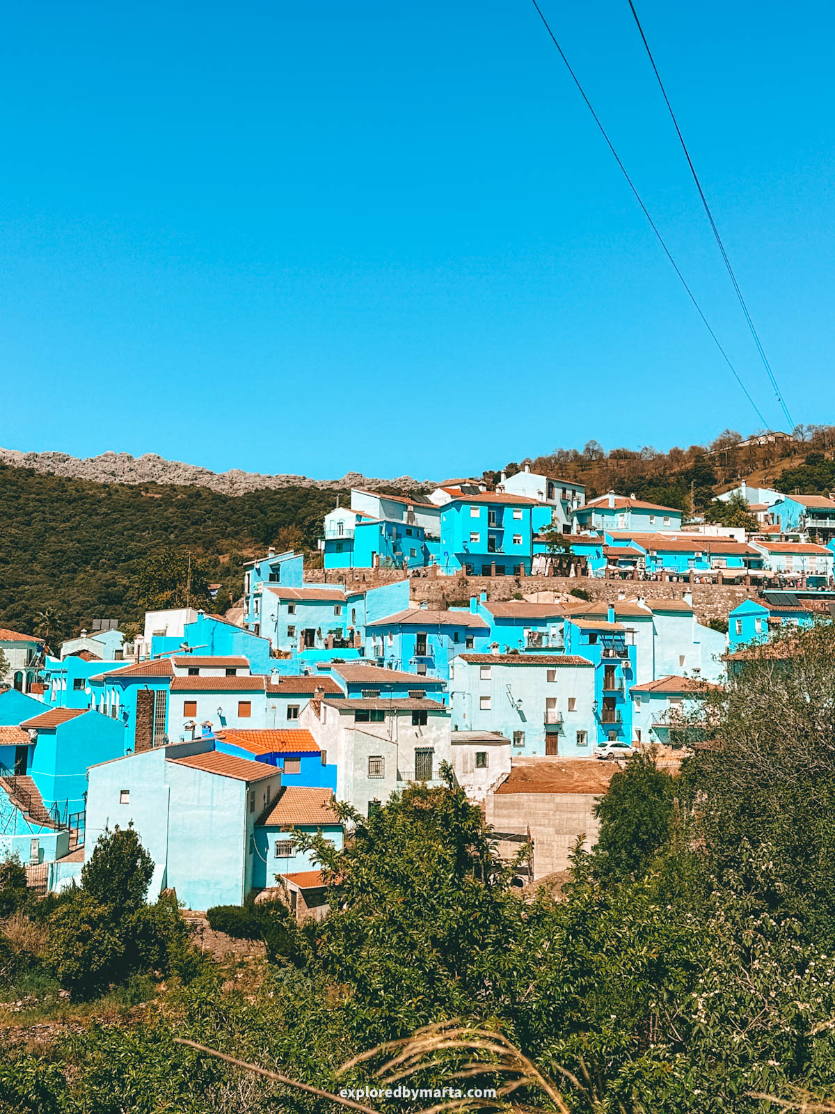 Beautiful view of the blue houses in Juzcar village in Spain