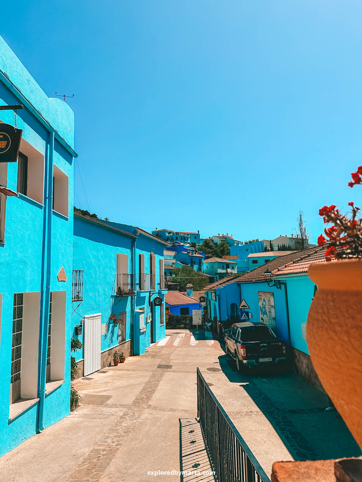 Blue painted houses on Calle Iglesia in the blue village of Juzcar in Spain